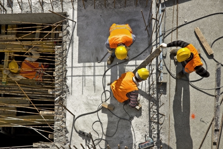 aerial view of construction workers in hard hats on site